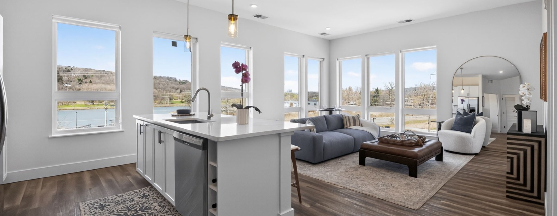 kitchen island with pendant lighting with views into the living room