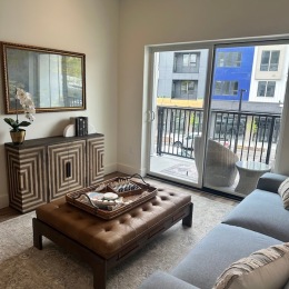 a living room with a couch, coffee table and a media console