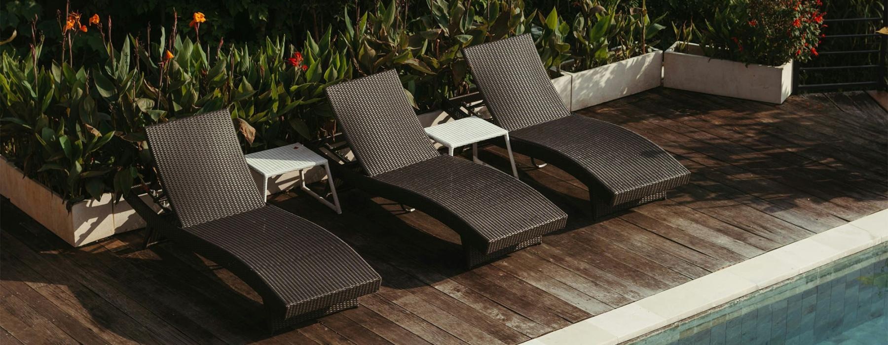 a group of chairs around a pool