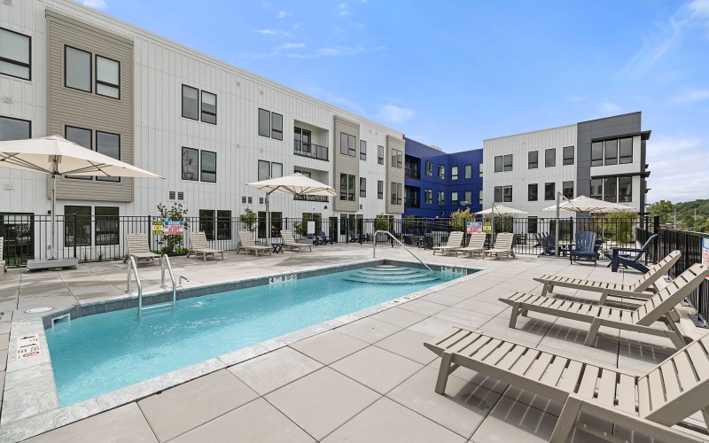 pool in a courtyard with lounge seating