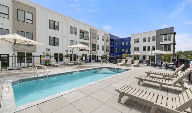 pool in a courtyard with lounge seating