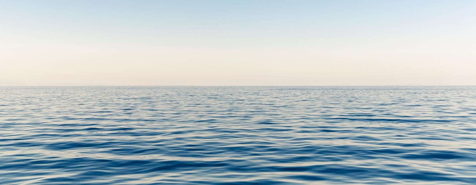 a body of water with blue sky